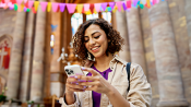 Image of woman on phone outside of church